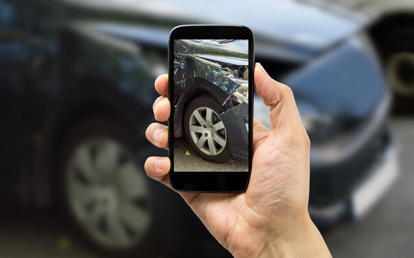 taking a picture of a wrecked car