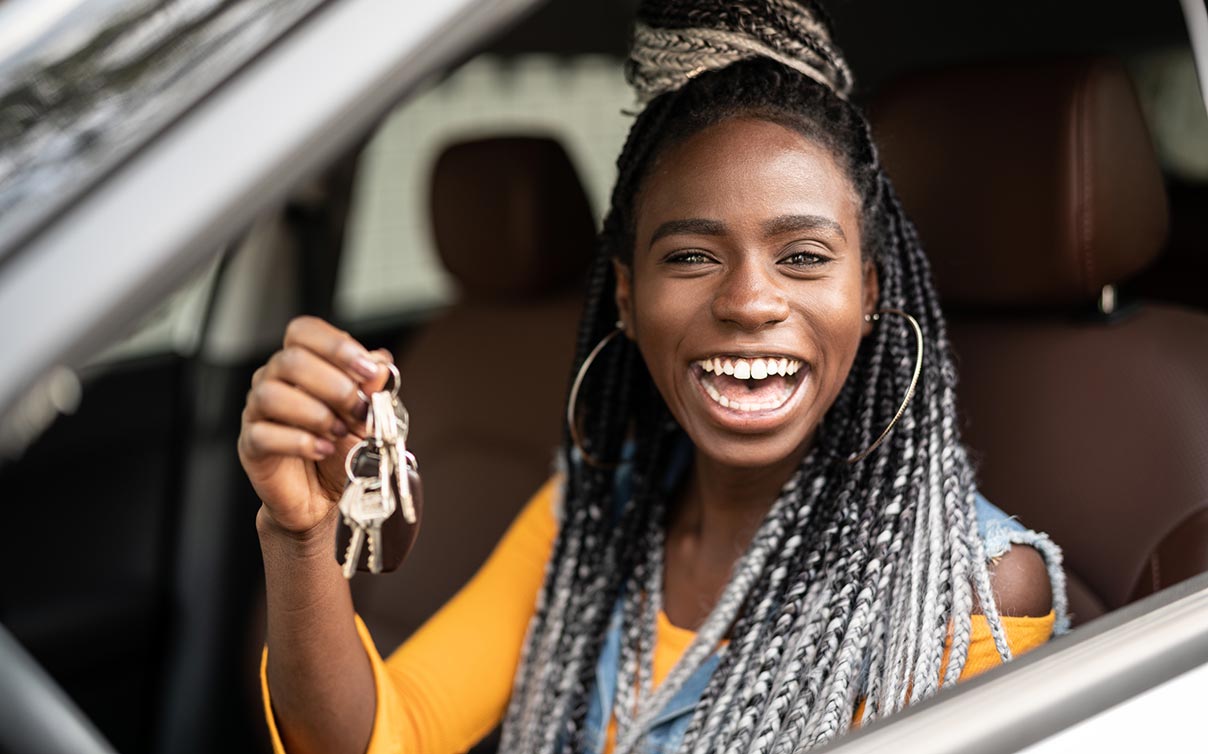 teenage girl holding keys