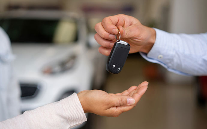 a person handing their keys to someone else